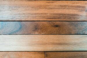 Horizontal planks of natural wood showcasing a smooth, textured surface with rich brown tones.